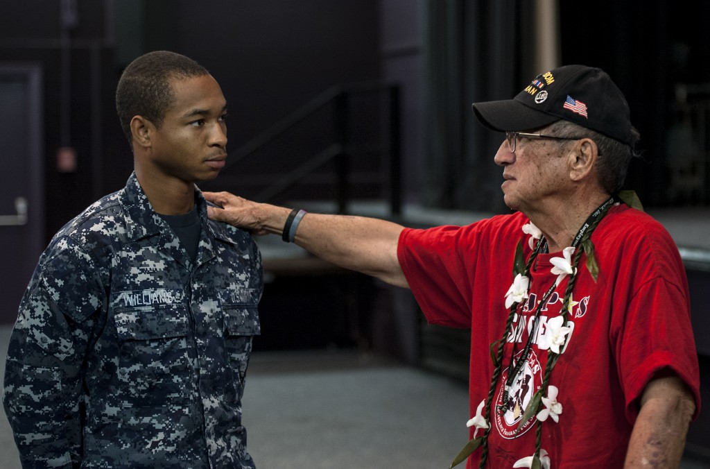 Ishmael W. Stagner II, retired Army, member of the Statewide Prevent Suicide Hawaii Task Force, speaks to Logistics Specialist Seaman Joshua Williams after a Suicide Prevention seminar at Sharkey Theater on Joint Base Pearl Harbor-Hickam. The Suicide Prevention Awareness month's theme is "Thrive in Your Community," encouraging everyone to get involved with their command and community to reach out to those in need, recognize the symptoms and prevent suicidal behavior.