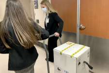 Shipment of Pfizer's COVID-19 vaccine is taken from FedEx truck to MD Anderson Cancer Center's pharmacy Monday morning.