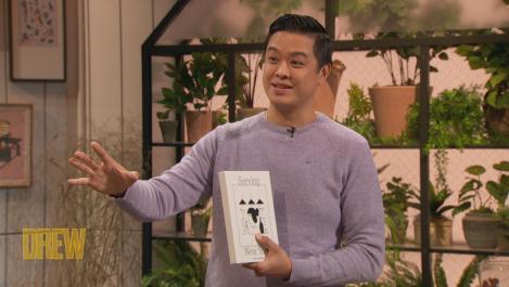 Wilson Tang holding a cookbook