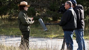 Park ranger talking to news reporter