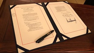 Signed law and pen on a desk