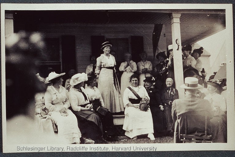 Suffrage meeting taking place on a porch, including Alice Stone Blackwell.