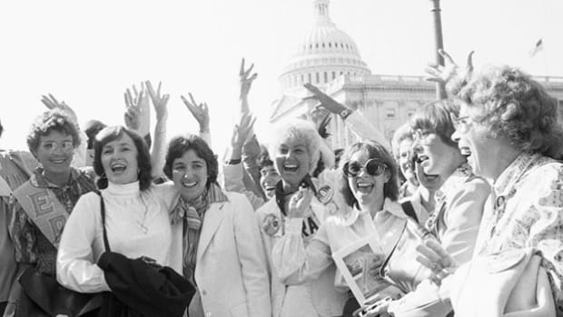 In August 1970, women's rights advocates staged rallies across the nation to commemorate the 50th anniversary of the adoption of the 19th Amendment, which granted suffrage to women. Participants show their solidarity in a group chant.