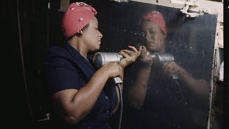 Woman operating hand drill, working on World War II plan. Library of Congress photo.