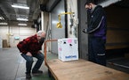 Minnesota Gov. Tim Walz inspects the first delivery of the Pfizer COVID-19 vaccine to the Minneapolis VA Hospital Monday morning, delivered by FedEx d