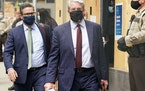 Robert Paule, center and Derek Chauvin's attorney Eric Nelson, at left, left the Hennepin County Family Justice Center following a hearing on several 