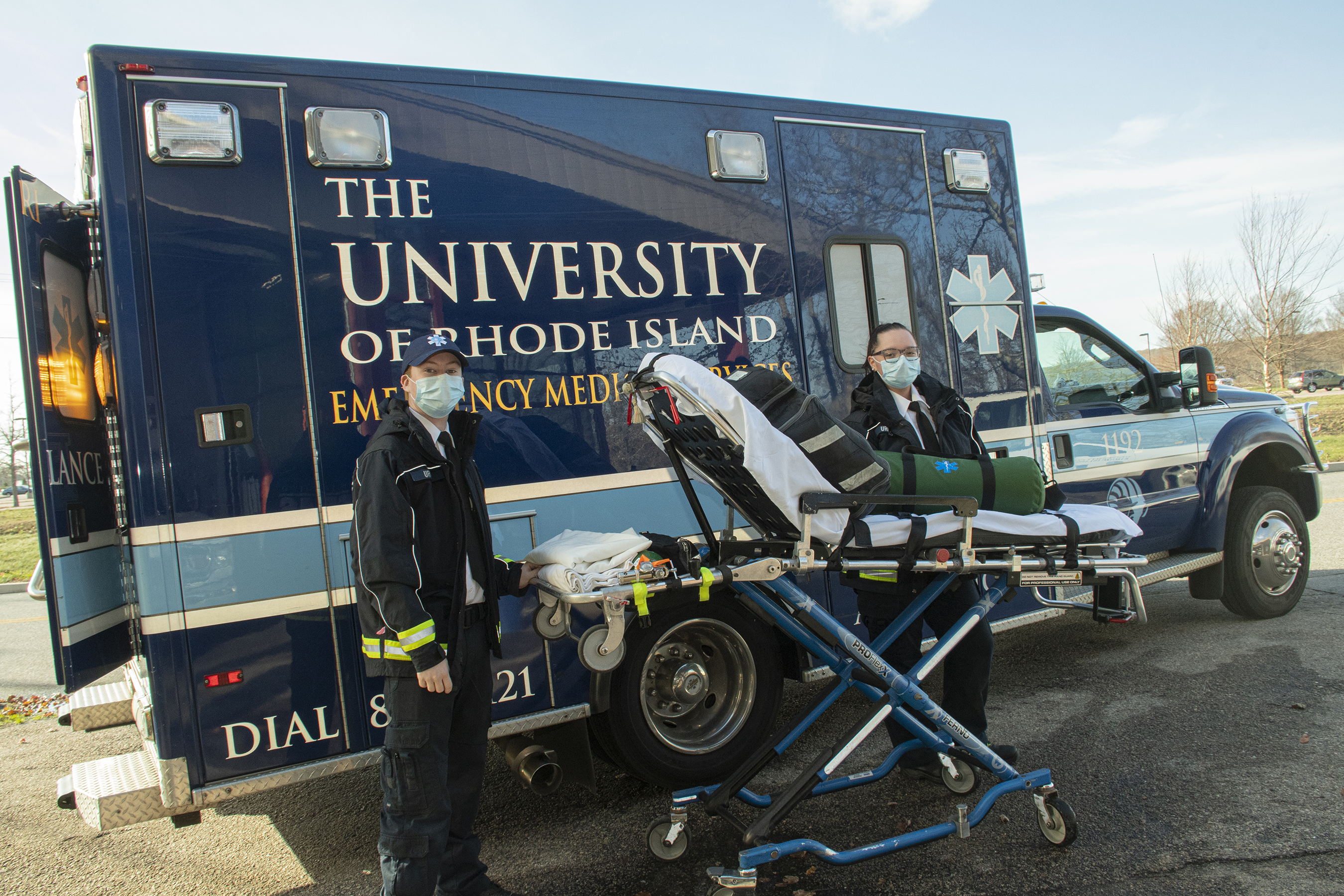 Lt. Michael Brennan, left, and Lt. Emma Ceres outside the URI EMS ambulance.