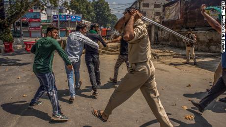 SRINAGAR, KASHMIR, INDIA - SEPTEMBER 08:  Indian policeman beat and detain Kashmiri Shiite mourners during curfew like restrictions in the city center on September 08, 2019 in Srinagar, the summer capital of Indian administered Kashmir, India. Dozens of Shiite Muslim mourners were detained by Indian police as they tried to take part in the procession during Muharram, the first month of Islamic lunar calendar. Muslims mourn the slaying of the Prophet Mohammed&#39;s grandson Imam Hussain, who was assassinated by his political rivals along with 72 companions in 680 AD in Iraq. India has banned any processions and similar public gatherings in Kashmir after a rebellion against Indian rule broke out in 1989. (Photo by Yawar Nazir/ Getty Images)