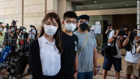 HONG KONG, CHINA - AUGUST5: Pro-democracy activist Agnes Chow Ting (L), Joshua Wong (C) and Ivan Lam Long-yin (R) speak to the press outside the court fon illegal assembly charges in relation to a protest outside the city&#39;s police headquarters in June 2019, at West Kowloon Magistrates&#39; Courts on August 5, 2020 in Hong Kong, China. (Photo by Billy H.C. Kwok/Getty Images)