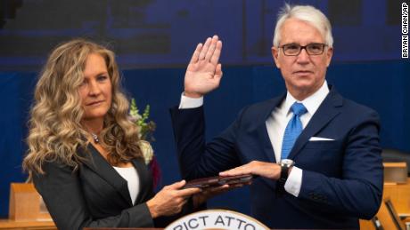 In this photo provided by the County of Los Angeles, incoming Los Angeles County District Attorney George Gascon is sworn in as his wife Fabiola Kramsky holds a copy of the Constitution during a mostly-virtual ceremony in downtown Los Angeles Monday, Dec. 7, 2020. Gascon, who co-authored a 2014 ballot measure to reduce some nonviolent felonies to misdemeanors, has promised more reforms to keep low-level offenders, drug users and those who are mentally ill out of jail and has said he won&#39;t seek the death penalty. (Bryan Chan/County of Los Angeles via AP)