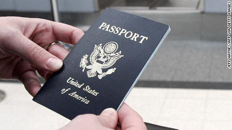 Chicago, UNITED STATES:  A passenger waits in line with her passport 23 January, 2007 before her Mexicana Air flight out of Chicago O&#39;Hare International airport in Chicago, Illinois.  As of 23 January, all Americans, Mexicans, Canadians and Bermudians traveling by air to the United States must for the first time carry a passport, said the Department of Homeland Security. The new measure is part of the department&#39;s Western Hemisphere Travel Initiative, following the recommendations of the National Commission on Terrorist Attacks on the United States, better known as the 9/11 Commission. It is aimed at making it more difficult for terrorists to enter the country with fake documents.  AFP PHOTO/JEFF HAYNES  (Photo credit should read JEFF HAYNES/AFP via Getty Images)