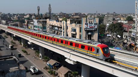 A newly built Orange Line Metro Train (OLMT), a metro project planned under the China-Pakistan Economic Corridor (CPEC), drives through on a track after an official opening in the eastern city of Lahore on October 26, 2020. (Photo by Arif ALI / AFP) (Photo by ARIF ALI/AFP via Getty Images)