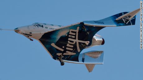 Virgin Galactic&#39;s VSS Unity comes in for a landing after its suborbital test flight on December 13, 2018, in Mojave, California. - Virgin Galactic marked a major milestone on Thursday as its spaceship made it to a peak height, or apogee, of 51.4 miles (82.7 kilometers), after taking off attached to an airplane from Mojave, California, then firing its rocket motors to reach new heights. (Photo by Gene Blevins / AFP)        (Photo credit should read GENE BLEVINS/AFP via Getty Images)