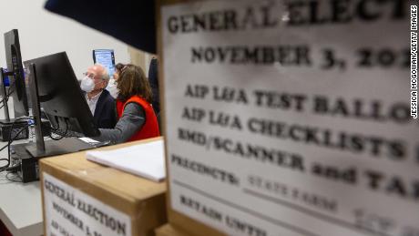 Members of an adjudication review panel look over scanned absentee ballots at the Fulton County Election Preparation Center on November 4, 2020 in Atlanta, Georgia. 