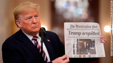 WASHINGTON, DC - FEBRUARY 06:  U.S. President Donald Trump holds a copy of The Washington Post as he speaks in the East Room of the White House one day after the U.S. Senate acquitted on two articles of impeachment, ion February 6, 2020 in Washington, DC. After five months of congressional hearings and investigations about President Trump's dealings with Ukraine, the U.S. Senate formally acquitted the president on Wednesday of charges that he abused his power and obstructed Congress. (Photo by Drew Angerer/Getty Images)
