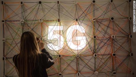 BARCELONA, SPAIN - FEBRUARY 26:  A staff member works next to a 5G logo at the Xiaomi booth on day 2 of the GSMA Mobile World Congress 2019 on February 26, 2019 in Barcelona, Spain. The annual Mobile World Congress hosts some of the world&#39;s largest communications companies, with many unveiling their latest phones and wearables gadgets like foldable screens and the introduction of the 5G wireless networks. (Photo by David Ramos/Getty Images)