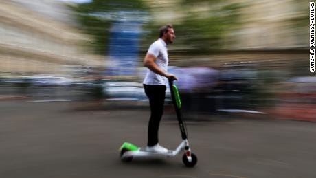A man rides a dock-free electric scooter Lime-S by California-based bicycle sharing service Lime during a presentation of new alternative urban mobility options at Paris city hall, France, July 19, 2018. REUTERS/Gonzalo Fuentes
