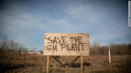 A spray painted billboard sign sits adjacent to the Lordstown GM plant