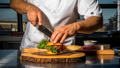 Moss Landing, CA - September 5, 2019: Chef Tucker Bunch prepares Sweet Earth&#39;s &quot;Awesome Burger&quot; in the test Kitchen at their Moss Landing headquarters. 
