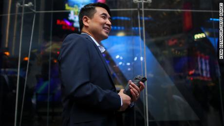 Zoom founder Eric Yuan poses in front of the Nasdaq building as the screen shows the logo of the video-conferencing software company Zoom after the opening bell ceremony on April 18, 2019 in New York City. The video-conferencing software company announced it&#39;s IPO priced at $36 per share, at an estimated value of $9.2 billion. (Photo by Kena Betancur/Getty Images)