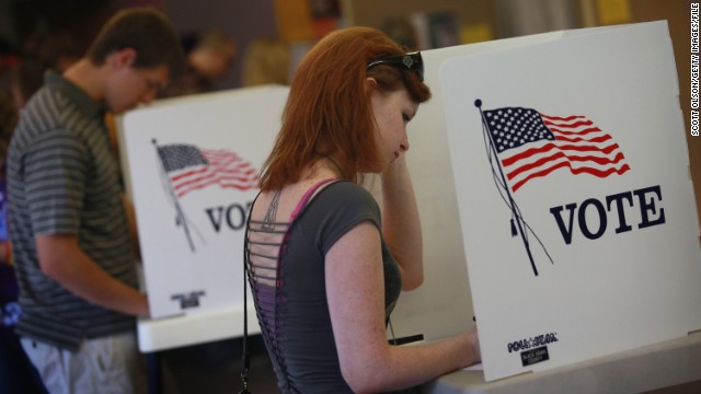 Student Courtney Johnson (R) votes on the campus of the University of Northern Iowa on September 28, 2012.
