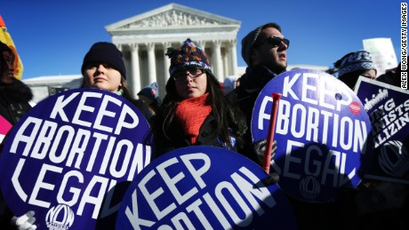 WASHINGTON, DC - JANUARY 22:  Pro-choice activists hold signs as marchers of the annual March for Life arrive in front of the U.S. Supreme Court January 22, 2014 on Capitol Hill in Washington, DC. Pro-life activists from all around the country gathered in Washington for the event to protest the Roe v. Wade Supreme Court decision in 1973 that helped to legalize abortion in the United States.  (Photo by Alex Wong/Getty Images)