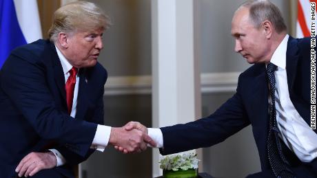 Russian President Vladimir Putin (R) and US President Donald Trump shake hands before a meeting in Helsinki, on July 16, 2018. (Photo by Brendan Smialowski / AFP)        (Photo credit should read BRENDAN SMIALOWSKI/AFP via Getty Images)