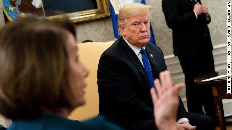 US President Donald Trump (R) listens while presumptive Speaker, House Minority Leader Nancy Pelosi (D-CA) makes a statement to the press before a meeting at the White House December 11, 2018 in Washington, DC. (Photo by Brendan Smialowski / AFP)        (Photo credit should read BRENDAN SMIALOWSKI/AFP via Getty Images)