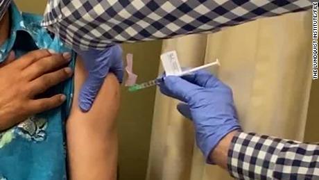 A man receives an injection as UCLA and AstraZeneca begin phase three trials in a potential COVID-19 vaccine.
