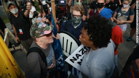 STONE MOUNTAIN, GA - AUGUST 15: A woman argues with a far-right protester during a rally on August 15, 2020 near the downtown of Stone Mountain, Georgia. Georgia&#39;s Stone Mountain Park which is famous for its large rock carving of Confederate leaders planned to close on Saturday in response to a planned right-wing rally. (Photo by Lynsey Weatherspoon/Getty Images)