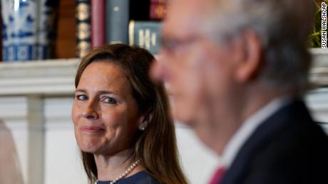 Supreme Court nominee Judge Amy Coney Barrett looks over to Senate Majority Leader Mitch McConnell of Ky., as they meet with on Capitol Hill in Washington, Tuesday, Sept. 29, 2020. (AP Photo/Susan Walsh, POOL)