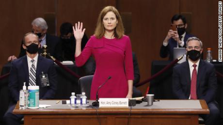 WASHINGTON, DC - OCTOBER 12:  Supreme Court Justice nominee Judge Amy Coney Barrett stands as she is sworn in during the Senate Judiciary Committee confirmation hearing for Supreme Court Justice in the Hart Senate Office Building on October 12, 2020 in Washington, DC. With less than a month until the presidential election, President Donald Trump tapped Amy Coney Barrett to be his third Supreme Court nominee in just four years. If confirmed, Barrett would replace the late Associate Justice Ruth Bader Ginsburg. (Shawn Thew-Pool/Getty Images)