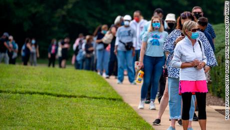 FAIRFAX, VIRGINIA - SEPTEMBER 18: People stand on line,  spaced six apart due to COVID-19, in order to vote early at the Fairfax Government Center on September 18, 2020 in Fairfax, Virginia. Voters waited up to four hours to early vote in the upcoming 2020 presidential election, polls opened at 8am, and people where in line at 5:45am according to poll workers. (Photo by Tasos Katopodis/Getty Images)