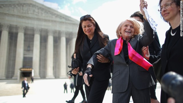 Edith Windsor, in a pink scarf, acknowledges her supporters as she leaves the Supreme Court on March 27 after arguments in her case challenging the constitutionality of the Defense of Marriage Act.