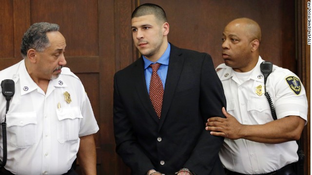 Former New England Patriots football player Aaron†Hernandez, center, is escorted by court officers as he enters Suffolk Superior Court before a hearing, Tuesday, June 24, 2014, in Boston. Prosecutors allege that Hernandez ambushed and shot to death two men, Daniel de Abreu and Safiro Furtado, in 2012 after a chance encounter inside a Boston nightclub. Hernandez has pleaded not guilty. (AP Photo/Steven Senne, Pool)