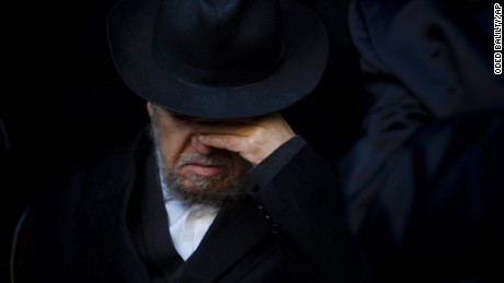 A relative of French Jew Yoav Hattab, a victim of the attack on kosher grocery store in Paris, attends his funeral procession in the city of Bnei Brak near Tel Aviv, Israel, Tuesday, Jan. 13, 2015. Israel geared up on Tuesday for the solemn funerals of four Jewish victims of a Paris terror attack on a kosher supermarket amid rising concerns over increased anti-Semitism in Europe. Hattab will be buried in Jerusalem with the other victims. (AP Photo/Oded Balilty/AP)