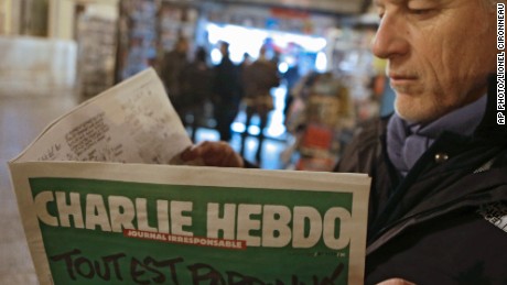 Jean Paul Bierlein reads the new Charlie Hebdo outside a newsstand in Nice, southeastern France, Wednesday, Jan. 14, 2015. In an emotional act of defiance, Charlie Hebdo resurrected its irreverent and often provocative newspaper, featuring a caricature of the Prophet Muhammad on the cover that drew immediate criticism and threats of more violence. The black letters on the front page reads: &quot;All is forgiven.&quot; (AP Photo/Lionel Cironneau)