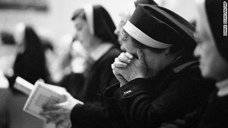 An unidentified Catholic nun holds her head in her hands during the funeral Mass for Sister Dorothy Kazel, the Ursuline nun killed in El Salvador, Dec. 11, 1980 in Cleveland. Burial is set for Thursday in Chardon, Ohio, east of Cleveland. 