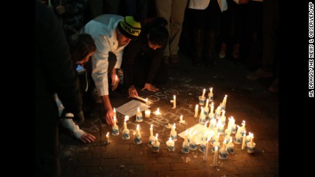 People light candles to honor the victims at UNC Chapel Hill on February 11.