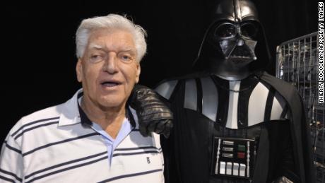 English actor David Prowse (L), who played the character of Darth Vader (Dark Vador in French) in the first Star Wars trilogy poses with a fan dressed up in a Darth Vader costume during a Star Wars convention on April 27, 2013 in Cusset. AFP PHOTO THIERRY ZOCCOLAN (Photo credit should read THIERRY ZOCCOLAN/AFP/Getty Images)