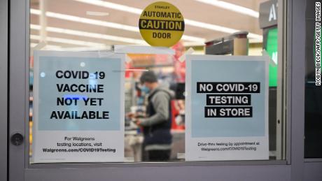 A sign on the entrance to a pharmacy reads &quot;Covid-19 Vaccine Not Yet Available&quot;, November 23, 2020 in Burbank, California. - British drugs group AstraZeneca and the University of Oxford said they will seek regulatory approval for their coronavirus vaccine, adding to hopes that a post-pandemic economy could be in the offing following similar announcements by Pfizer/BioNTech and Moderna. (Photo by Robyn Beck/AFP/Getty Images)