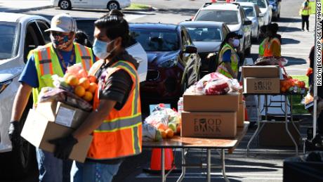 Volunteers load free groceries into cars for people experiencing food insecurity due to the coronavirus pandemic, December 1, 2020 in Los Angeles, California. 