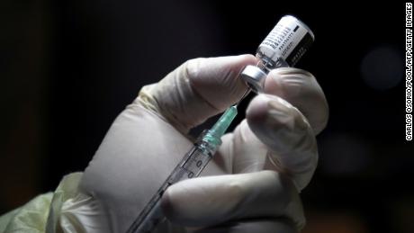 A healthcare worker prepares to administer a Pfizer/BioNTEch coronavirus disease (Covid-19) vaccine at The Michener Institute, in Toronto, Ontario on December 14, 2020. - Ontario, Canada&#39;s most populous province and one of the hardest hit by the pandemic, had 1,940 new cases and 23 deaths on Monday.  The province is expected to give its next doses to nursing home workers as a priority, according to media reports. (Photo by CARLOS OSORIO / POOL / AFP) (Photo by CARLOS OSORIO/POOL/AFP via Getty Images)