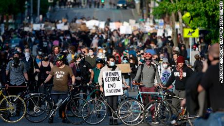 Protesters form a bicycle line as they protest the death of George Floyd in the Capitol Hill neighborhood of Seattle, Washington on June 1, 2020. - Major US cities -- convulsed by protests, clashes with police and looting since the death in Minneapolis police custody of George Floyd a week ago -- braced Monday for another night of unrest. More than 40 cities have imposed curfews after consecutive nights of tension that included looting and the trashing of parked cars. (Photo by Jason Redmond / AFP) (Photo by JASON REDMOND/AFP via Getty Images)