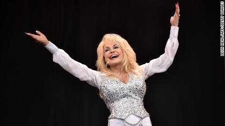 US country music singer Dolly Parton performs on the Pyramid Stage, on the final day of the Glastonbury Festival of Music and Performing Arts on Worthy Farm in Somerset, southwest England, on June 29, 2014.  AFP PHOTO / LEON NEAL        (Photo credit should read LEON NEAL/AFP via Getty Images)