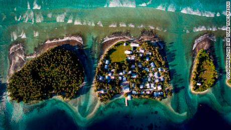 An overhead view of Ejit, center, with the ocean to the north and a lagoon to the south, of the Marshall Islands, Oct. 29, 2015. As policymakers discuss a climate change accord in Paris, rising sea levels are already an inescapable part of daily life in the Marshall Islands. (Josh Haner/The New York Times)