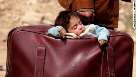 A child sleeps in a bag in the village of Beit Sawa, eastern Ghouta, Syria, March 15, 2018. Picture taken March 15, 2018. REUTERS/Omar Sanadiki/File Photo   SEARCH &quot;POY DECADE&quot; FOR THIS STORY. SEARCH &quot;REUTERS POY&quot; FOR ALL BEST OF 2019 PACKAGES. TPX IMAGES OF THE DAY.