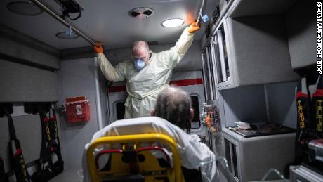 STAMFORD, CONNECTICUT - APRIL 04: (EDITORIAL USE ONLY)  Paramedic Randy Lilly, wearing personal protection equipment (PPE), rides in an ambulance  with a male patient showing COVID-19 symptoms on April 04, 2020 in Stamford, Connecticut. Cases of coronavirus have been unusually high in the African American community. Stamford now has more than 1,000 confirmed coronavirus cases, the highest of any city in Connecticut. The majority of Stamford EMS calls are now for COVID-19 patients. (Photo by John Moore/Getty Images)