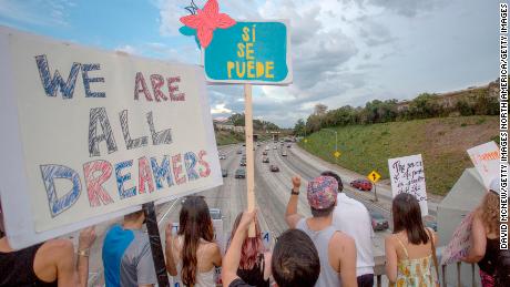 LOS ANGELES, CA - SEPTEMBER 10: People hold signs over the 110 freeway as thousands of immigrants and supporters join the Defend DACA March to oppose the President Trump order to end DACA on September 10, 2017 in Los Angeles, California. The Obama-era Deferred Action for Childhood Arrivals program provides undocumented people who arrived to the US as children temporary legal immigration status for protection from deportation to a country many have not known, and a work permit for a renewable two-year period. The order exposes about 800,000 so-called ÒdreamersÓ who signed up for DACA to deportation. About a quarter of them live in California. Congress has the option to replace the policy with legislation before DACA expires on March 5, 2018.  (Photo by David McNew/Getty Images)