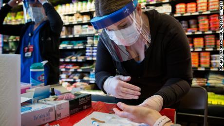 NEW YORK, April 25, 2020: A healthcare worker takes a sample from a woman at a New York State Department of Health COVID-19 antibody testing center at Steve&#39;s 9th Street Market in Brooklyn, New York, the United States, on April 25, 2020. Global COVID-19 deaths surpassed 200,000 on Saturday afternoon, according to the Center for Systems Science and Engineering ,CSSE, at Johns Hopkins University. A total of 200,698 people have died of the disease as of 1:50 p.m. 1750 GMT, among 2,865,938 cases worldwide, the CSSE data showed. The United States suffered the most fatalities at 52,782 as its total cases reached 924,576. (Photo by Michael Nagle/Xinhua via Getty) (Xinhua/ via Getty Images)